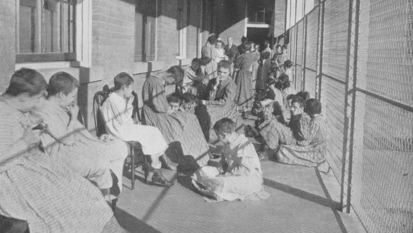 Black and white photo of residents requiring 24-hour care in Custodial Cottage C.