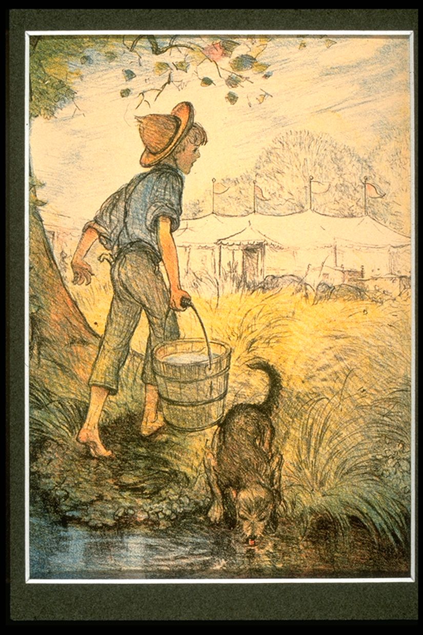 a boy with a bucket and his dog by the river with a tent in the background