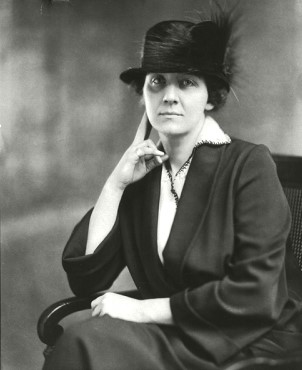 Black and white photograph of a young lady wearing a feathered hat